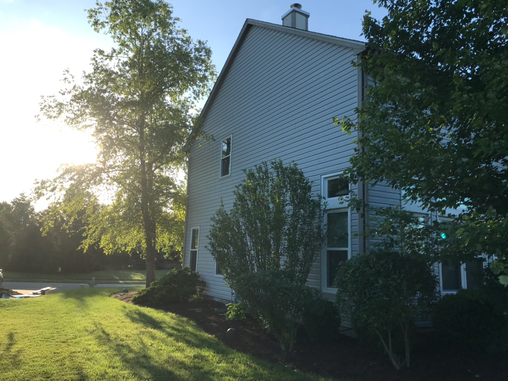 Sun shining on home with new fiber cement siding