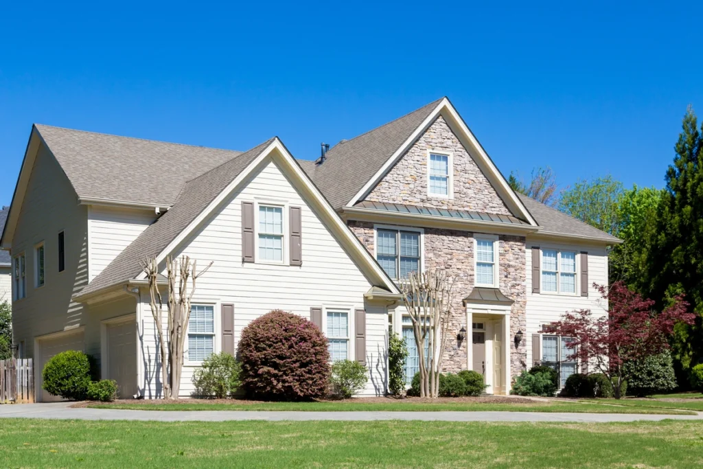 Beautiful outside view of a home with stone and fiber cement siding with blue sky