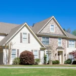 Beautiful outside view of a home with stone and fiber cement siding with blue sky