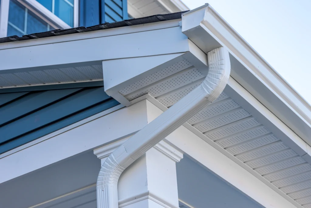 close-up of a blue house with new white gutters