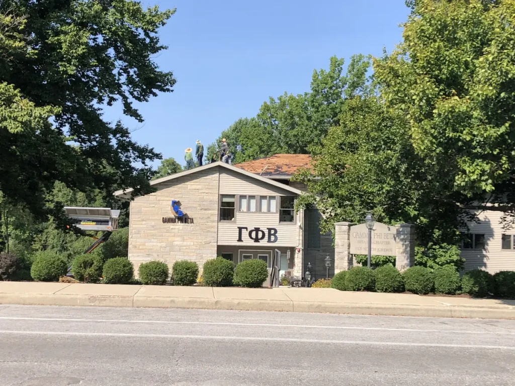 rapid roofing working on college sorority roof